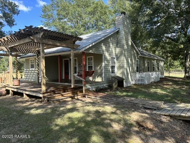 6757 Line Rd, Ethel, LA 70730 - back of property featuring a pergola, a chimney, a yard, and a wooden deck