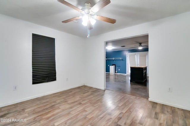 empty room featuring ceiling fan and hardwood / wood-style flooring