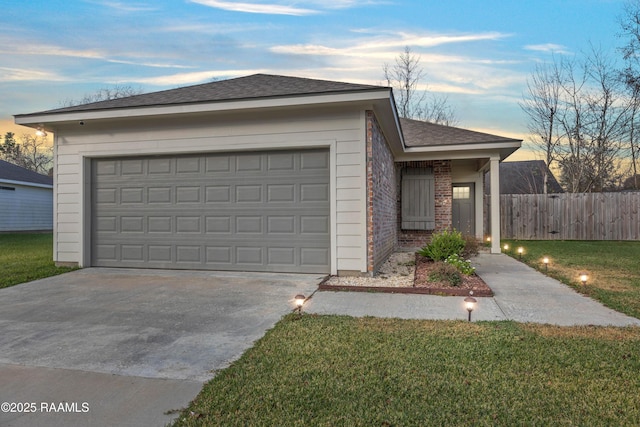 ranch-style home with a garage and a lawn