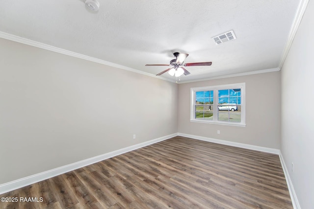 spare room featuring crown molding, ceiling fan, dark wood-type flooring, and a textured ceiling