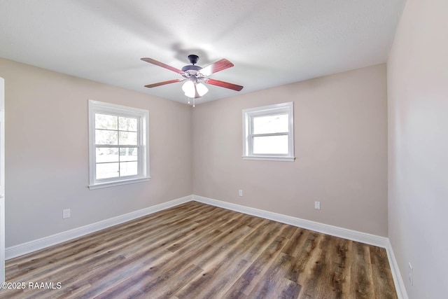 spare room featuring ceiling fan, dark hardwood / wood-style flooring, and a textured ceiling