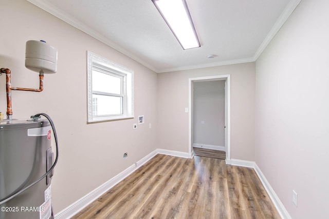 laundry room with hookup for a washing machine, light hardwood / wood-style floors, ornamental molding, and water heater