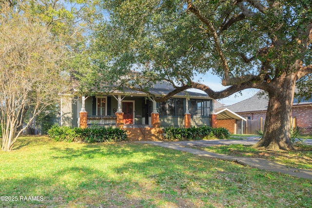 view of front of home with a front yard and covered porch