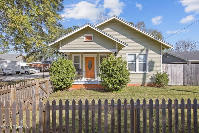 bungalow-style home with a front lawn and a porch