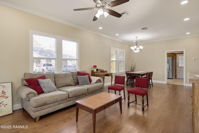 living room featuring ornamental molding, ceiling fan with notable chandelier, and wood-type flooring