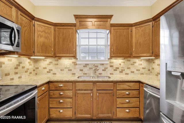 kitchen featuring appliances with stainless steel finishes, decorative backsplash, light stone counters, and sink