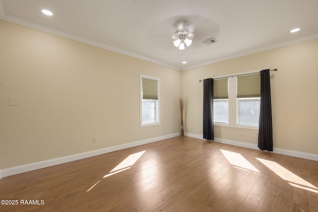 unfurnished room featuring ceiling fan, ornamental molding, a healthy amount of sunlight, and light hardwood / wood-style floors