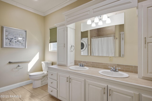 bathroom with toilet, tasteful backsplash, vanity, ornamental molding, and washer / clothes dryer