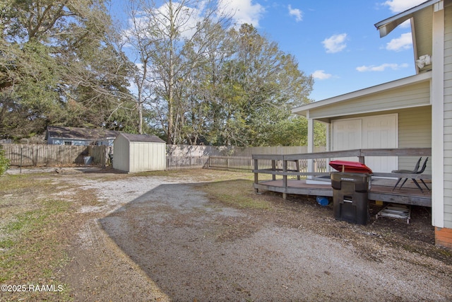 view of yard with a wooden deck and a shed