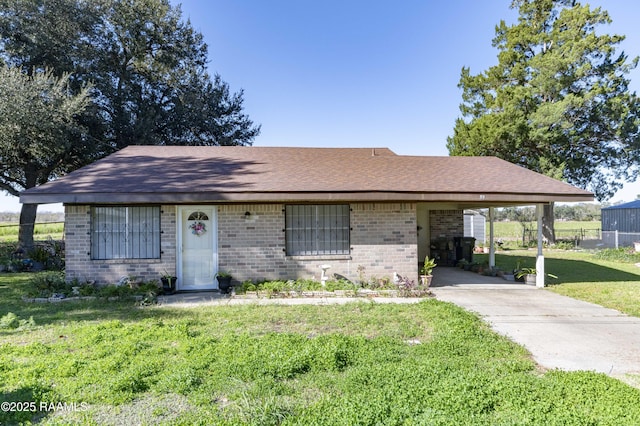 ranch-style house with a front yard and a carport