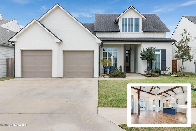 modern farmhouse with a garage, driveway, roof with shingles, board and batten siding, and a front yard