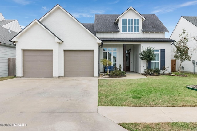 modern inspired farmhouse with a shingled roof, concrete driveway, board and batten siding, a front yard, and a garage