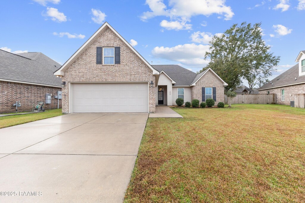 front facade with a front yard