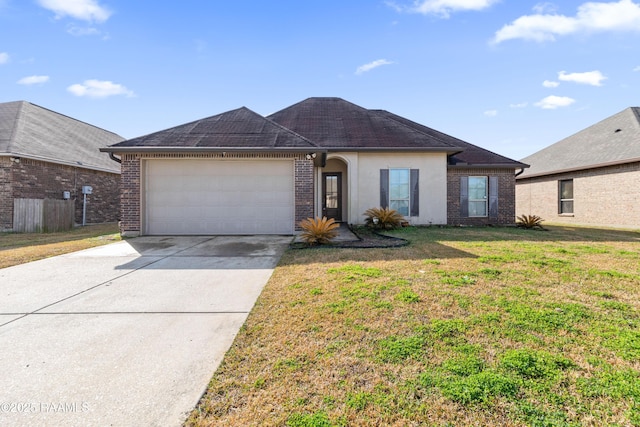 ranch-style home with a garage and a front lawn