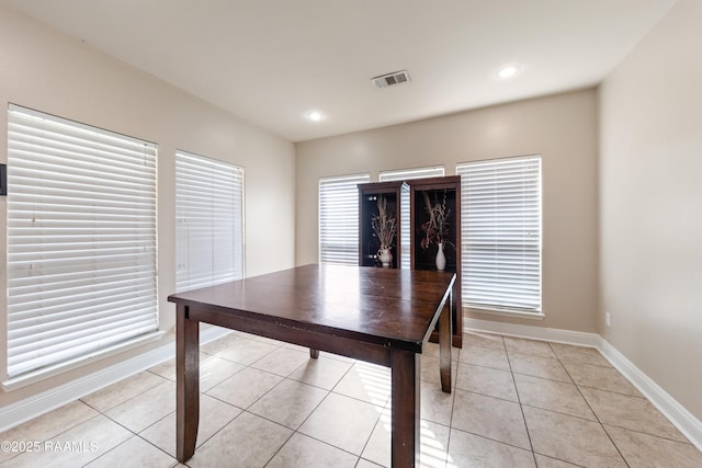 unfurnished office featuring light tile patterned floors and a wealth of natural light