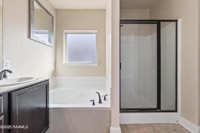 bathroom featuring vanity, tile patterned flooring, and plus walk in shower