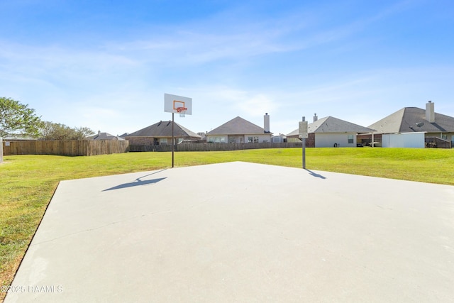 view of basketball court with a lawn