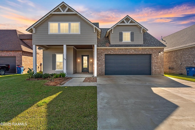 front facade featuring a lawn and a garage