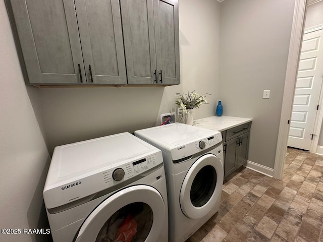 washroom with separate washer and dryer and cabinets