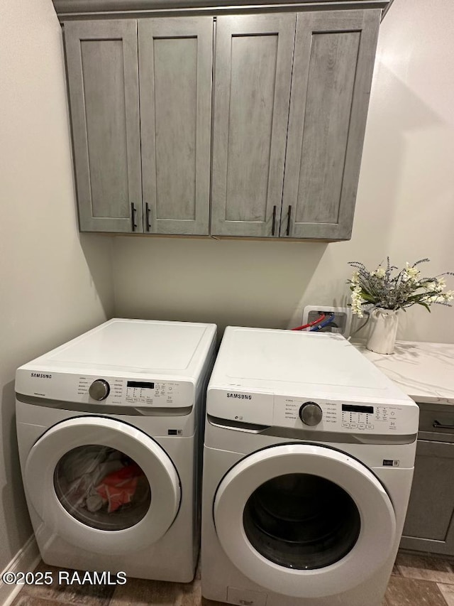 washroom featuring cabinets and independent washer and dryer