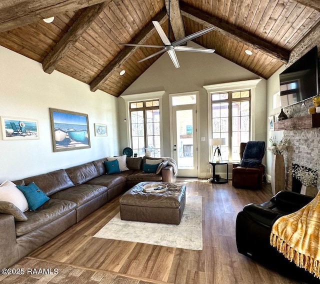 living room with beamed ceiling, dark hardwood / wood-style flooring, high vaulted ceiling, and wooden ceiling