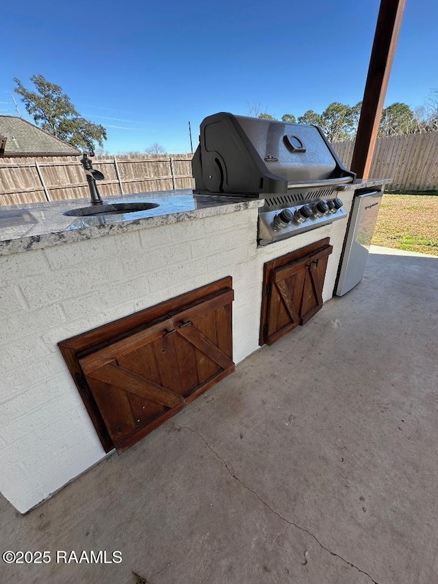 view of patio featuring area for grilling and a grill