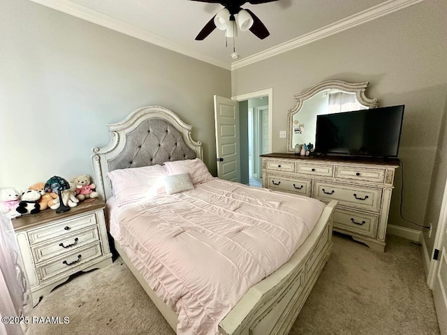 carpeted bedroom featuring ornamental molding and ceiling fan