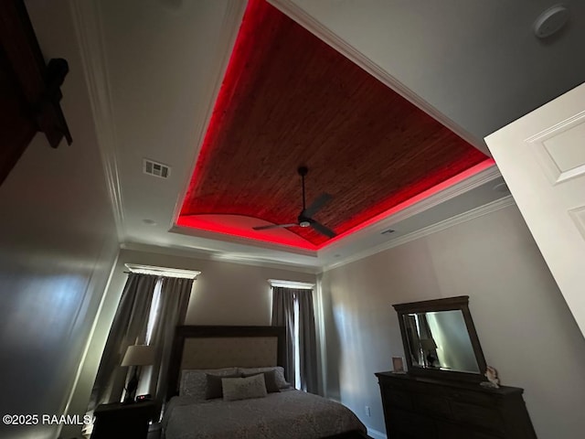 bedroom featuring crown molding, wooden ceiling, and a tray ceiling