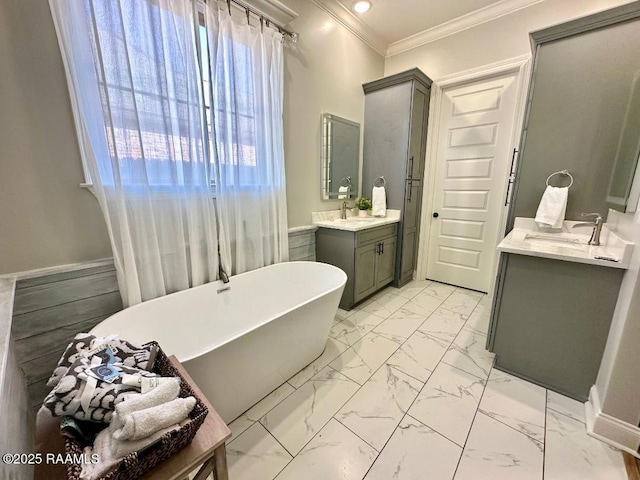 bathroom featuring ornamental molding, vanity, and a bath