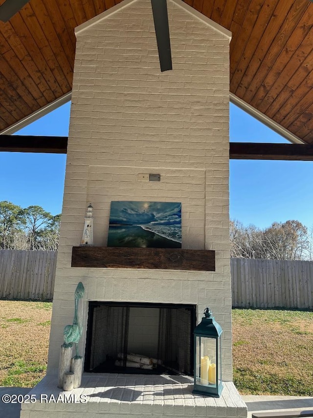 view of side of property featuring an outdoor brick fireplace