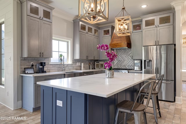 105 Ember Grove Xing, Lafayette, LA 70508 - kitchen featuring stainless steel refrigerator with ice dispenser, ornamental molding, a chandelier, a kitchen island, and light stone countertops