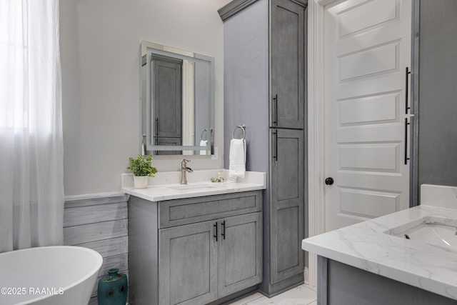 105 Ember Grove Xing, Lafayette, LA 70508 - bathroom featuring two vanities, a freestanding bath, and marble finish floors