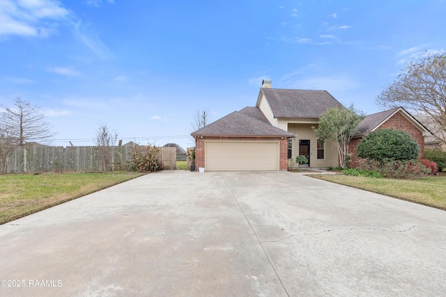 view of front of house with a garage and a front lawn