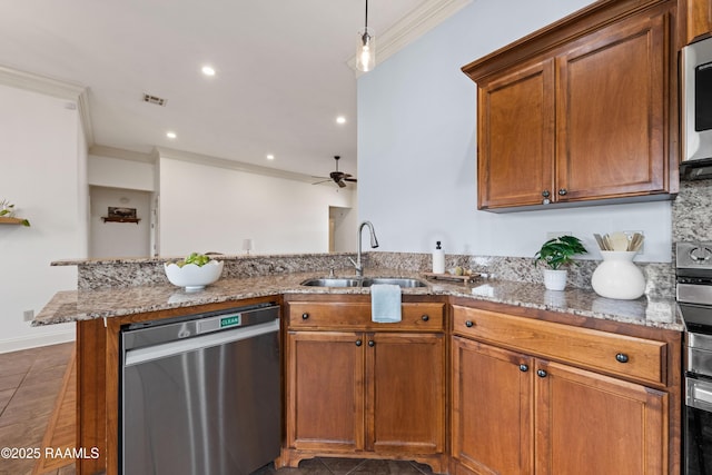 kitchen featuring appliances with stainless steel finishes, sink, ornamental molding, kitchen peninsula, and light stone counters