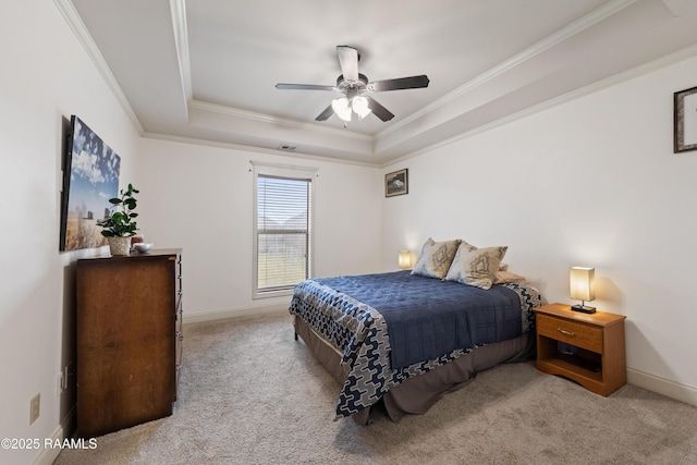 carpeted bedroom featuring ceiling fan, ornamental molding, and a raised ceiling