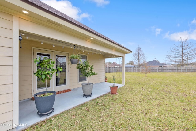 view of yard featuring a patio area and french doors