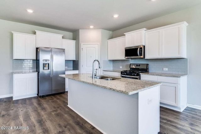 kitchen with white cabinetry, a kitchen island with sink, and stainless steel appliances