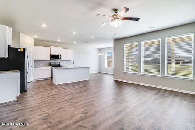 kitchen featuring white cabinetry, wood-type flooring, sink, a kitchen island with sink, and stainless steel appliances