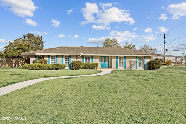 ranch-style home featuring a front yard