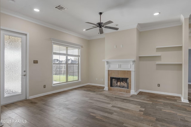 unfurnished living room featuring a tile fireplace, ceiling fan, crown molding, and hardwood / wood-style flooring