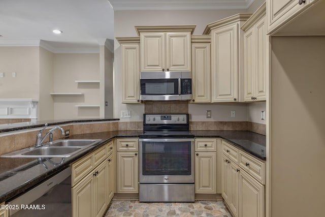 kitchen with ornamental molding, sink, cream cabinetry, and appliances with stainless steel finishes