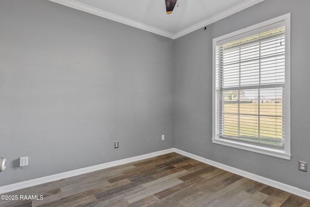 spare room with dark hardwood / wood-style flooring, ceiling fan, and ornamental molding