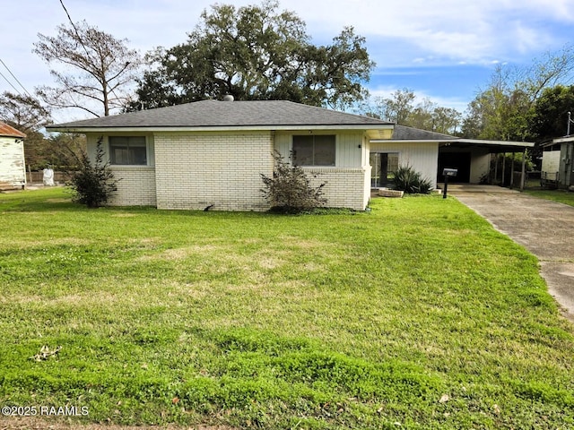 single story home with a front lawn and a carport