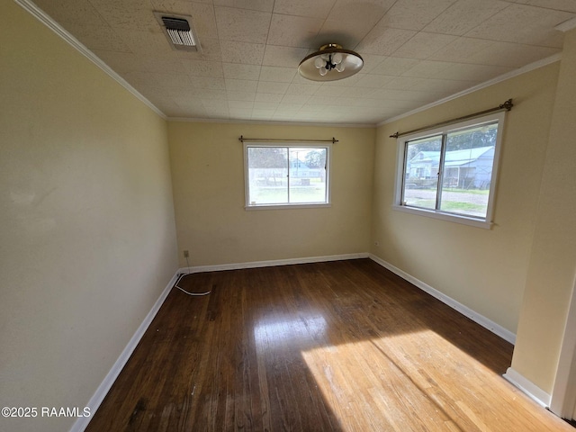 unfurnished room featuring crown molding and hardwood / wood-style floors