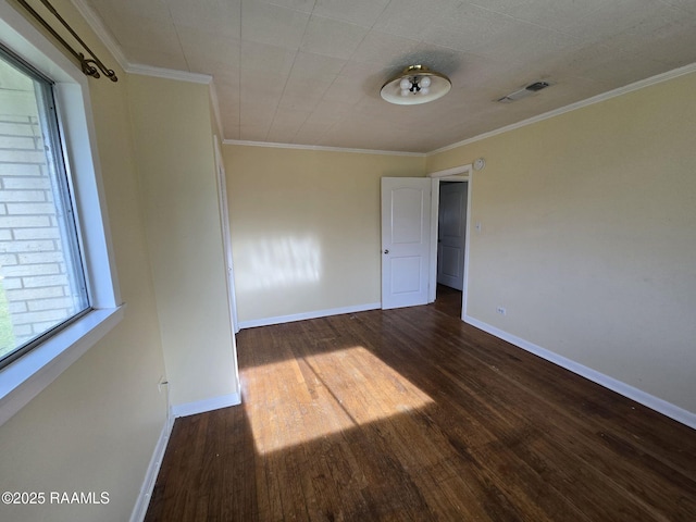 spare room featuring crown molding and dark hardwood / wood-style flooring