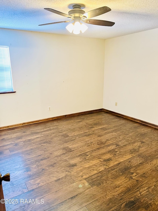 unfurnished room with ceiling fan, dark wood-type flooring, and a textured ceiling