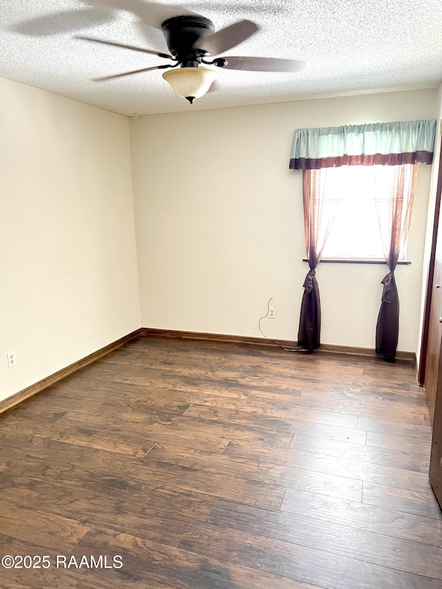 spare room with dark hardwood / wood-style flooring and a textured ceiling