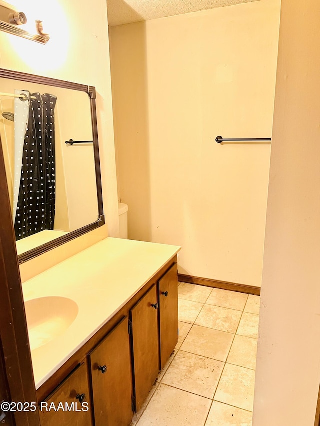 bathroom with vanity, tile patterned floors, and a textured ceiling