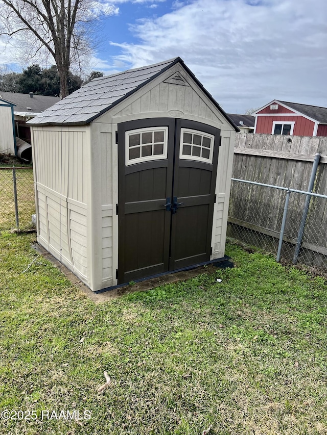 view of outbuilding with a yard