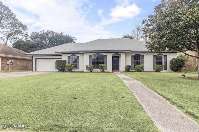 ranch-style home with a garage and a front lawn